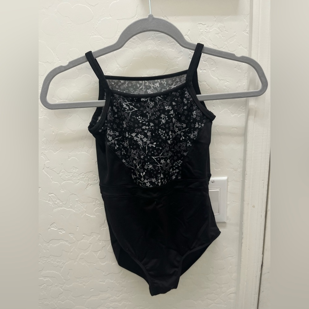 Black leotard with white and gray flowers on top with a mesh back
